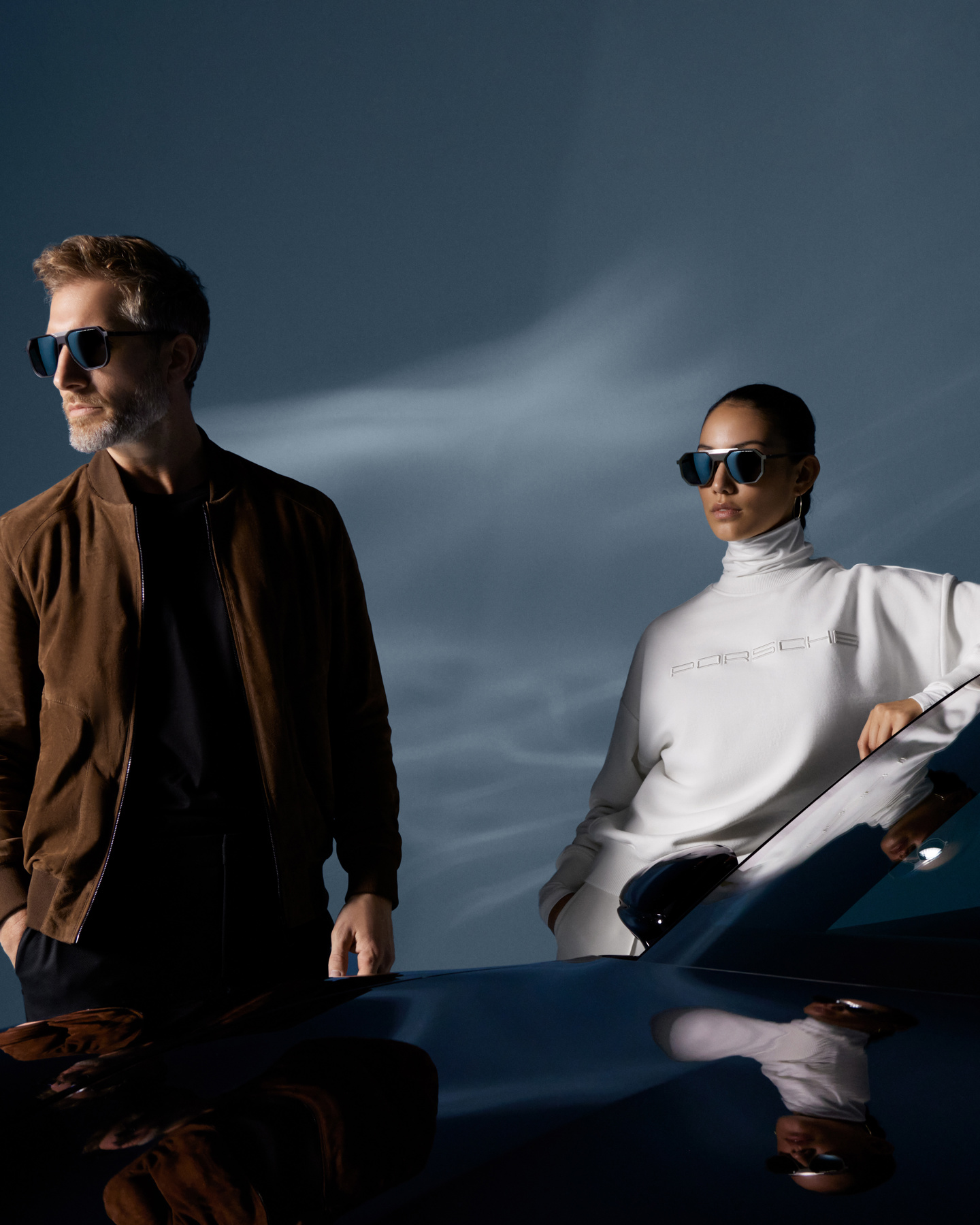 Shows Picture of man-and-woman-standing-next-to-porsche-car-wearing-porsche-design-fashion-v2.jpg