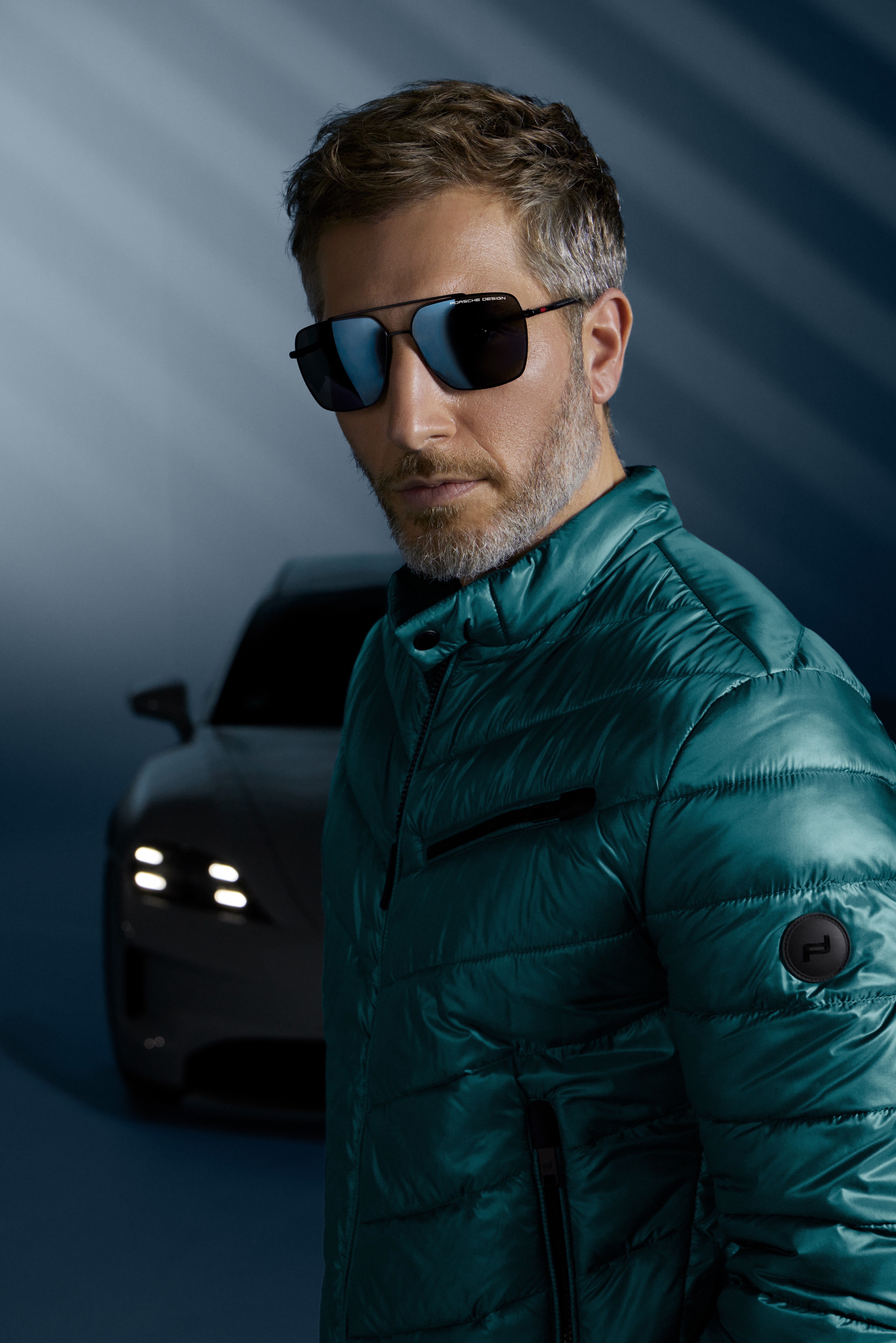 Shows Picture of man-wearing-winter-jacket-and-porsche-design-eyewear-porsche-in-back.jpg
