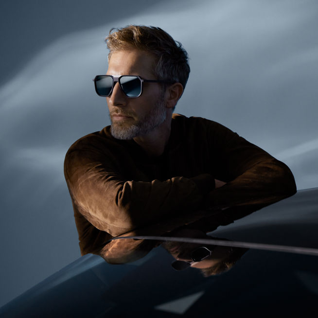Shows Picture of man-leaning-on-car-wearing-leather-jacket-and-sunglasses.jpg