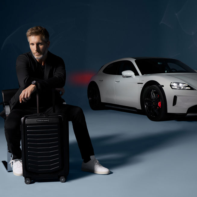 Shows Picture of man-sitting-with-trolley-porsche-in-back.jpg