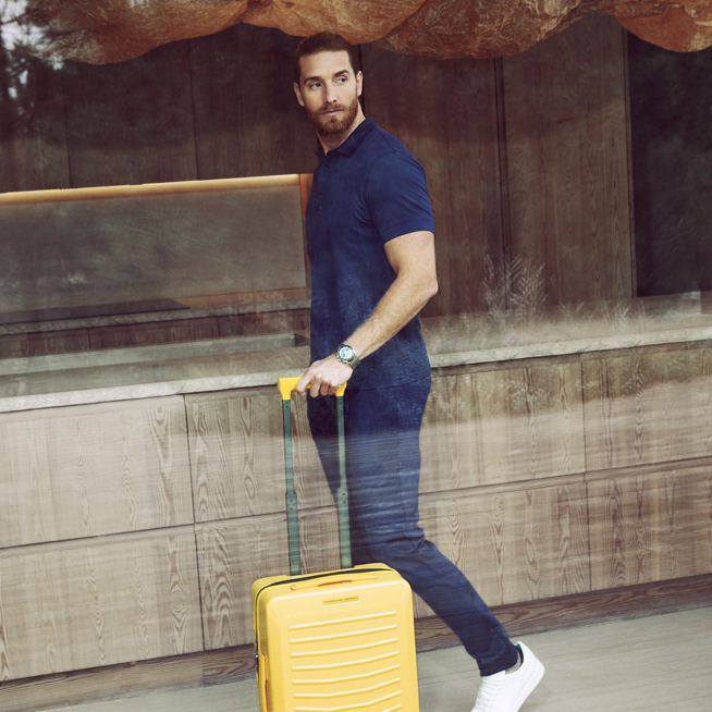 Shows Picture of man-with-racing-yellow-suitcase-blue-outfit.png