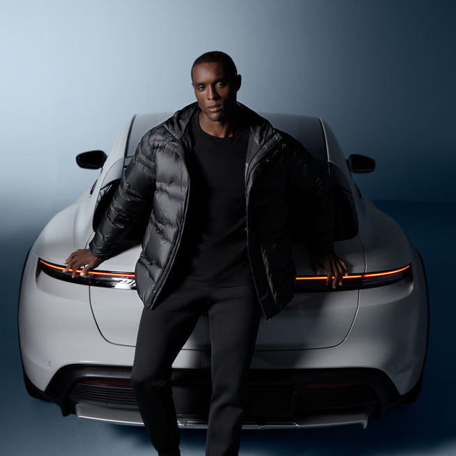 Shows Picture of man-wearing-porsche-design-fashion-in-front-of-white-porsche.jpg