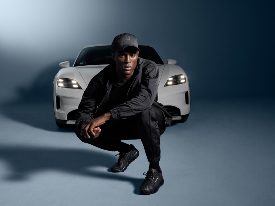 Shows Picture of man-wearing-porsche-design-sportswear-in-front-of-white-porsche.jpg